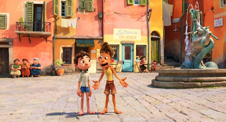 Luca and Alberto stand in a picturesque Italian plaza.